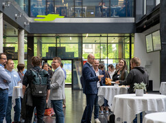 Teilnehmer eines Kongresses unterhalten sich in der Aula der FH St. Pölten...